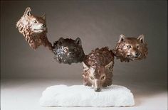 three different animal heads on top of a white towel in front of a gray background