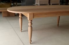 a wooden table sitting on top of a tile floor