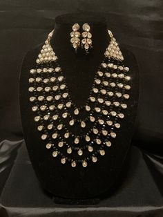 Rich Ethnic Taste is what this Item stands  for. Look elegant and stand out in crowd when U go out in this extraordinary design which is an ensemble of Multikundan, Multistranded gorgeous piece in white kundan and black beads.  Can't ask for more 🥰 White Bollywood Jewelry Sets For Party, Festive Black Jewelry Sets For Party, Beaded Kundan Jewelry Sets For Party, White Kundan Necklace With Mirror Work For Party, Elegant Black Kundan Necklace, Elegant Black Kundan Necklace For Celebrations, White Kundan Necklace With Stone Work For Party, Black Jewelry For Diwali Party, Elegant Party Jewelry Sets With Mirror Work