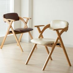 two chairs sitting side by side in an empty room