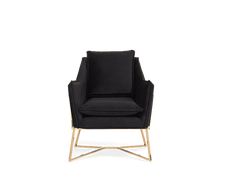 a black chair with gold legs and a black cushion on the back, in front of a white background