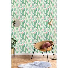 a room with a cactus wallpaper and a chair in front of a rug on the floor