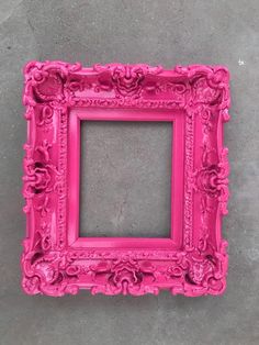 a pink frame sitting on top of a cement floor