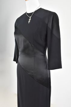 Elegance & Sophistication are exemplified in this 1940/50s EISENBERG ORIGINAL black crepe and satin dress. Diagonal wide bands show off the contrast in fabric. Elbow darts are present on the 3/4 length sleeves. Metal zipper is center back. The dress is not lined. It is in exceptional condition and a must have for the collector. EISENBERG started as a wholesaler in ladies fashion in Chicago in 1914. He was born Jonas Eisenberg in Austria, and came to the USA in the 1880s. When his sons, Sam a Classic Fitted Evening Dress For Formal Occasions, Classic Evening Dress With Fitted Bodice, Classic Black Fitted Evening Dress, Fitted Dinner Dress With Bias Cut, Classic Silk Evening Dress For Cocktail, Classic Silk Cocktail Evening Dress, Classic Black Evening Dress, Elegant Silk Evening Dress For Formal Occasions, Elegant Silk Evening Dress For Formal Events