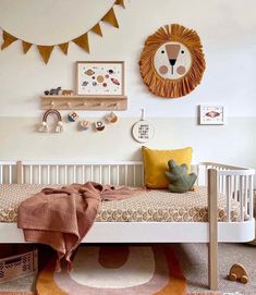 a child's room with a bed, rugs and pictures on the wall