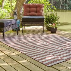 two chairs sitting on top of a wooden deck