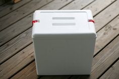 a white box sitting on top of a wooden floor