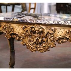 an ornately decorated table with marble top