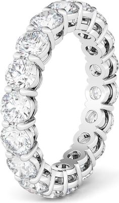 a white gold ring with round cut diamonds on the sides and an intertwined band