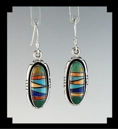 "These handcrafted earrings have been inlaid with a number of different stones giving them a wonderful array of color. For this pair the artist used turquoise, spiny oyster, lapis and malachite. The stone are inlaid in a geometric pattern and finished with a notched edge. Specifics:  Metal: Sterling Stamped   Stones: Turquoise, Spiny Oyster, Lapis, Malachite  Type of Earring:  Ear Wire Size of Earrings: 1 \" by 1/2\"  not counting the ear wire or 1 ½\" long with the ear wire. Weight of Earrings: 6.6 grams  Signed: M MT- 1707" Southwestern Multicolor Round Earrings, Unique Colorful Jewelry With Matching Earrings, Artisan Multicolor Jewelry With Inlay, Unique Multicolor Sterling Silver Earrings, Southwestern Style Earrings With Natural Stones For Gifts, Handmade Multicolor Oval Earrings, Southwestern Natural Stone Earrings For Gifts, Bohemian Multicolor Multi-stone Earrings, Multicolor Multi-stone Teardrop Earrings