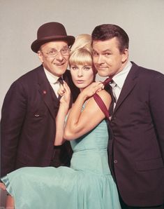 two men and a woman posing for a photo