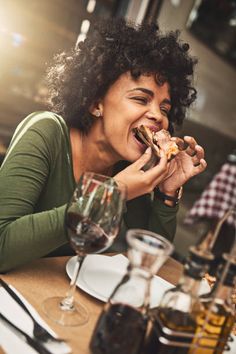 a woman sitting at a table eating food