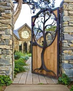 an open wooden door with a tree design on the front and side entrance to a stone building