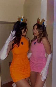 two women dressed in costumes standing next to each other