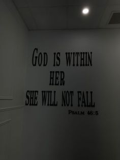 there is a sign on the wall that says god is within her she will not fall