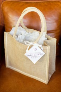 a brown leather chair with a bag on top of it and a price tag hanging from the handle