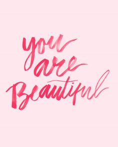 the words you are beautiful written in pink ink