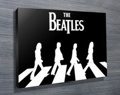 the beatles album cover is displayed on a wooden wall with black and white silhouettes