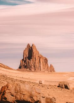 a large rock formation in the middle of a desert