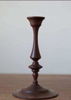 a wooden candle holder sitting on top of a table