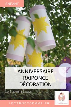 three paper cups hanging from a tree with the words, annversaire rapponce decoration