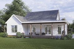 a small white house sitting on top of a lush green field