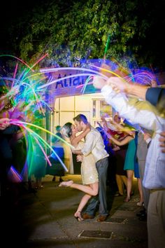 a man and woman dancing with fireworks in the background