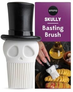 a white skull with a black top hat on it's head is being used as a brush