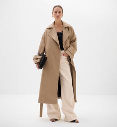 Chic Oversized Cotton Outerwear, Chic Long Cotton Coat, Oversized Gabardine Outerwear For Work, Oversized Outerwear With Belted Cuffs For Work, Modern Belted Spring Outerwear, Chic Spring Gabardine Outerwear, Chic Belted Cotton Outerwear, Oversized Belted Outerwear For Work, Chic Oversized Belted Outerwear