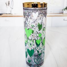 a green and white vase sitting on top of a counter