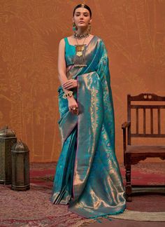 Experience luxury and tradition with our Premium Turquoise Blue Copper Zari Handloom Saree. Perfect for weddings and festive parties, this stylish sari features intricate all over weaving and comes with a matching blouse. Elevate your wardrobe with this unique and elegant piece.(Double your style with this unique Turquoise Blue Copper sari that is perfect for special occasions! With its intricate handloom weaving and matching blouse, you'll be the talk of the party. The unstitched blouse can be Blue Art Silk Choli For Transitional Season, Blue Blouse Piece For Wedding In Transitional Season, Blue Bollywood Wedding Blouse Piece, Transitional Blue Art Silk Choli, Turquoise Saree-style Lehenga For Wedding, Wedding Blue Meenakari Blouse Piece, Elegant Turquoise Saree For Festivals, Blue Festive Blouse Piece For Transitional Season, Semi-stitched Blue Meenakari Blouse Piece