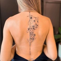 a woman with a tattoo on her back that has a lion and arrow in it