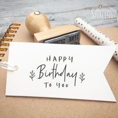 a happy birthday to you card with rubber stamp on it next to some crafting supplies