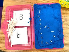 two plastic trays filled with blue and white letters