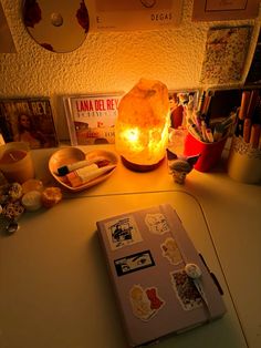 an open book sitting on top of a table next to a lamp and other items