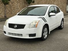 a white car parked in a parking lot