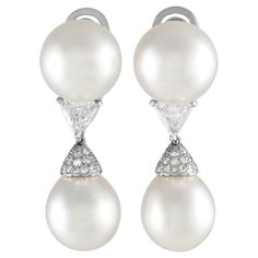 These Cartier earrings are ideal for even your most special occasions. The stunning 14mm Pearls are expertly accented by triangular Diamonds with a total weight of 2.05 carats and additional Diamond accents totaling 0.35 carats. Crafted from shimmering Platinum, each one measures 1.65 long by 0.50 wide.This jewelry piece is offered in estate condition and include the manufacturer's box. Luxury Pear-shaped Diamond Earrings For Evening, Gia Certified Luxury Diamond Earrings For Formal Occasions, Platinum Pear-shaped Diamond Earrings For Formal Occasions, Formal Pear-shaped Platinum Earrings, Luxury Cartier Diamond Earrings, Elegant Cartier Diamond Earrings, Luxury White Gold Clip-on Diamond Earrings, Luxury Pear-shaped Earrings With Diamond Accents, Pear-shaped Diamond Earrings For Formal Events