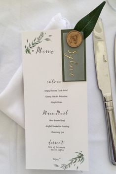 a table setting with silverware and menu cards