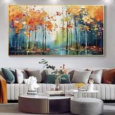 a living room filled with furniture and a large painting on the wall above it's coffee table