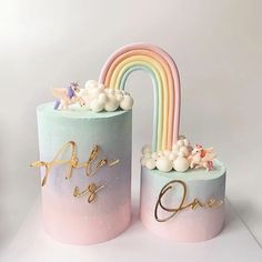 two pastel colored cakes decorated with rainbows and clouds