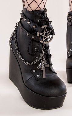 The Poison wedge series feature wickedly stylish designs. Cages and cute charms and chains, oh my! Vegan Black PU leather 5 inch platform Ankle bootie Pentagram charm Studded straps Side zip Studded heel Chains with cross charms Lace up U.S women's sizing-refer to size chart for more info Platform Goth Boots, Gothic Platform Ankle Boots, Alternative Boots, Boots With Chains, Goth Heels, Goth Platform Boots, Platforms Shoes, Demonia Boots, Estilo Harajuku