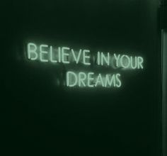 a neon sign that says believe in your dreams