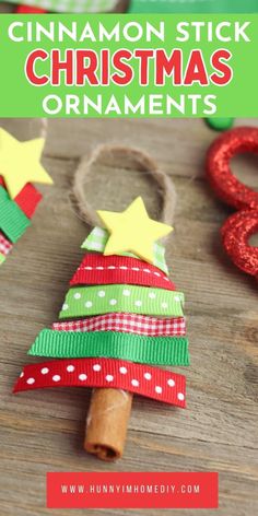 cinnamon stick christmas tree ornament made out of paper and ribbon on a wooden table