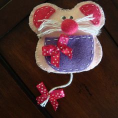 a mouse made out of felt with red bows