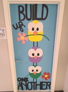 a door decorated with paper flowers and the words build up one another