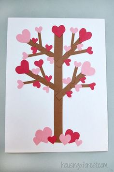 a paper cut out of a tree with hearts on it