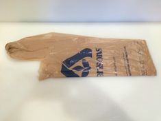 a plastic bag that is on top of a white table with a black and blue logo