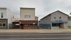 an empty street in front of two buildings