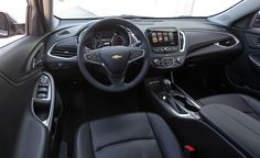 the interior of a car with black leather seats and steering wheel, dash lights, and dashboard controls