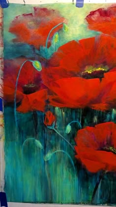 an abstract painting of red poppies on a green background